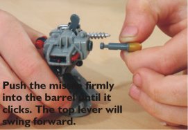 Push the missile firmly into the barrel until it clicks. The top lever will swing forward.